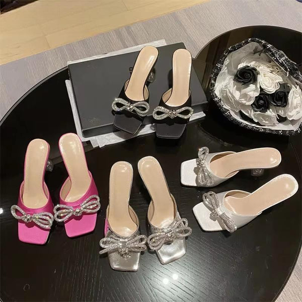Pantuflas con nudo de mariposa y cristales brillantes para mujer, a la moda, con punta cuadrada y tacones bajos transparentes.